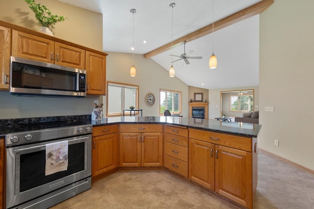 2475 Mossy Creek Dr NE, Owatonna, MN 55060 - kitchen featuring appliances with stainless steel finishes, a glass covered fireplace, a peninsula, and brown cabinetry