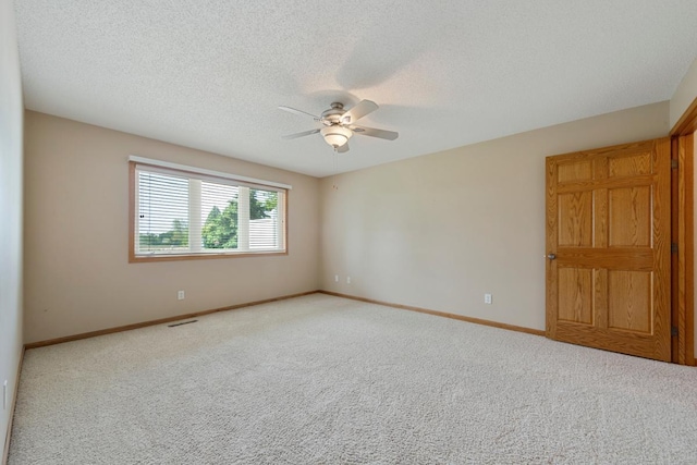 2475 Mossy Creek Dr NE, Owatonna, MN 55060 - carpeted spare room featuring ceiling fan and a textured ceiling