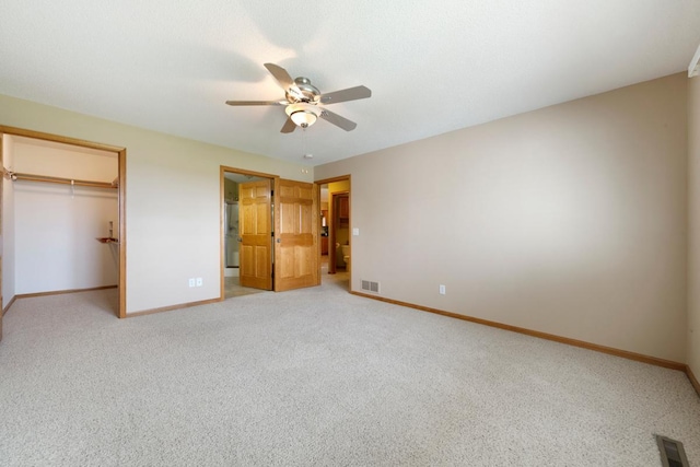 2475 Mossy Creek Dr NE, Owatonna, MN 55060 - unfurnished bedroom featuring light carpet, a spacious closet, a closet, and ceiling fan