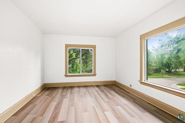 1006 87th Ave W Upper Unit, Upper Unit, Duluth, MN 55808 - spare room with healthy amount of natural light, light wood finished floors, and baseboards