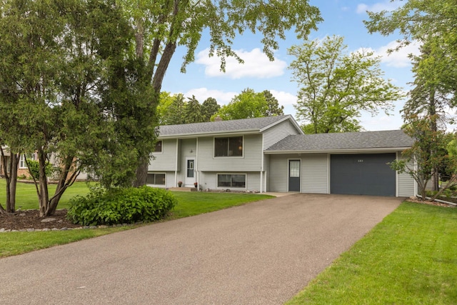 685 County Road C W, Roseville, MN 55113 - raised ranch featuring a garage, driveway, a front yard, and roof with shingles