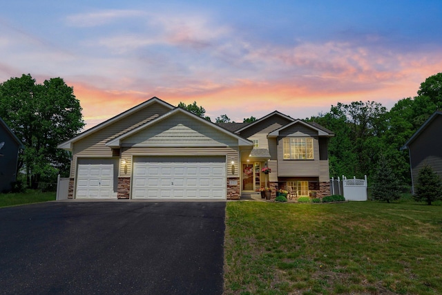 13137 13th Ave N, Zimmerman, MN 55398 - tri-level home featuring driveway, stone siding, and an attached garage
