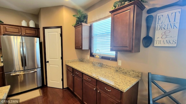 9695 Independence Cir Unit 4, Chanhassen, MN 55317 - kitchen with freestanding refrigerator, dark wood-style floors, and light stone countertops