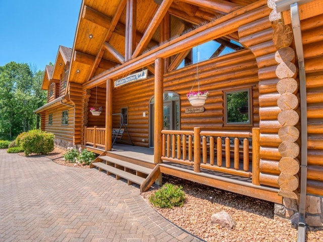 10719 Lumberjack Rd NW, Alaska Twp, MN 56667 - property entrance featuring log siding and a porch