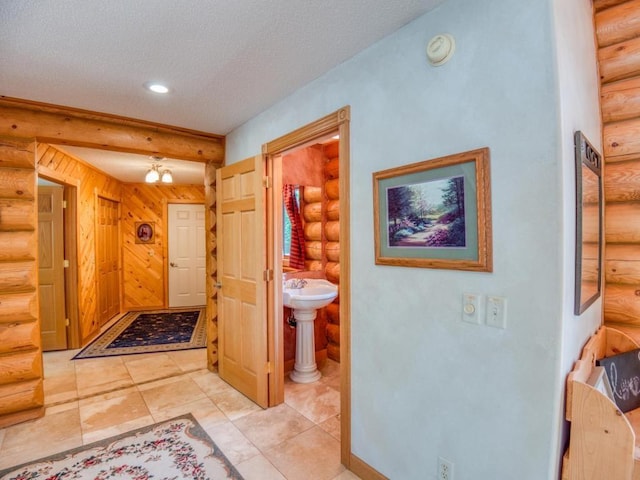 10719 Lumberjack Rd NW, Alaska Twp, MN 56667 - corridor featuring log walls, a textured ceiling, and recessed lighting