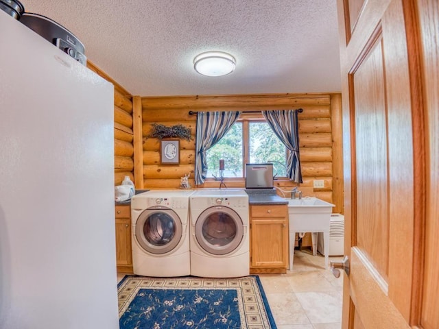10719 Lumberjack Rd NW, Alaska Twp, MN 56667 - laundry room with log walls, cabinet space, washing machine and clothes dryer, a textured ceiling, and an office area