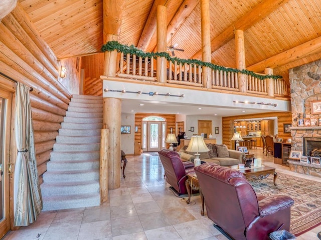 10719 Lumberjack Rd NW, Alaska Twp, MN 56667 - living area with wooden ceiling with exposed beams, log walls, stairway, high vaulted ceiling, and a fireplace