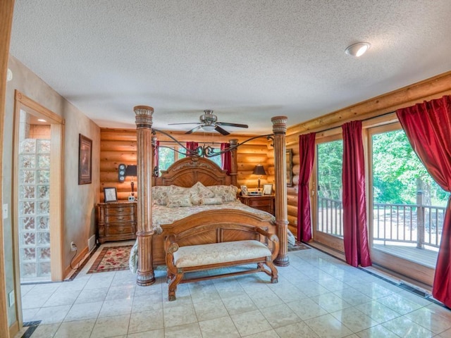 10719 Lumberjack Rd NW, Alaska Twp, MN 56667 - bedroom featuring log walls, a textured ceiling, and access to outside