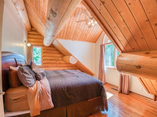 10719 Lumberjack Rd NW, Alaska Twp, MN 56667 - bedroom with rustic walls, hardwood / wood-style flooring, and vaulted ceiling