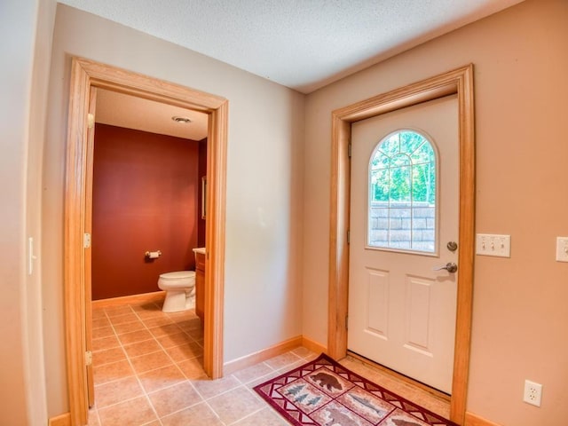 10719 Lumberjack Rd NW, Alaska Twp, MN 56667 - foyer with light tile patterned floors, baseboards, and a textured ceiling