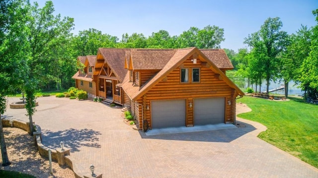10719 Lumberjack Rd NW, Alaska Twp, MN 56667 - log home featuring log exterior, a front yard, decorative driveway, and roof with shingles