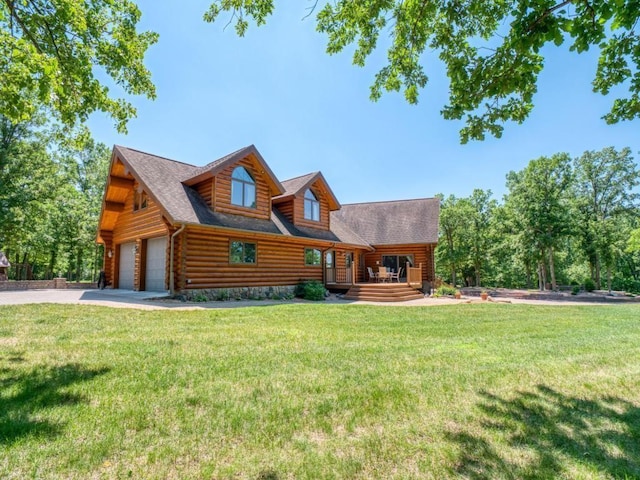 10719 Lumberjack Rd NW, Alaska Twp, MN 56667 - log cabin featuring concrete driveway, a front lawn, a garage, and log siding