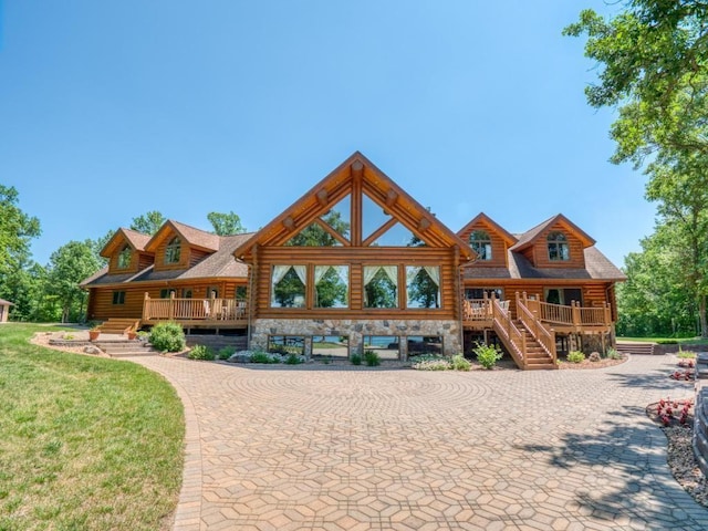 10719 Lumberjack Rd NW, Alaska Twp, MN 56667 - view of front of home with stairway, covered porch, log exterior, and stone siding