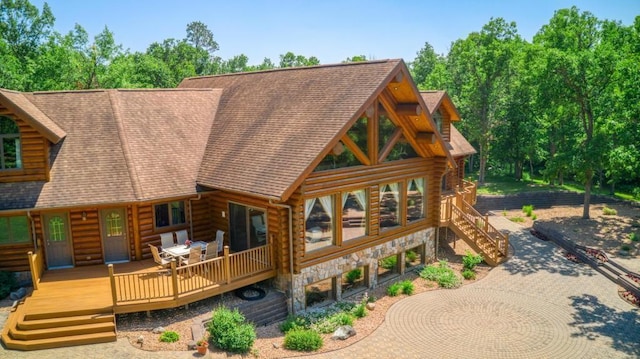 10719 Lumberjack Rd NW, Alaska Twp, MN 56667 - back of property with log siding, stone siding, a deck, stairway, and roof with shingles