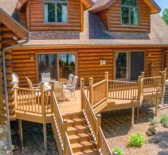 10719 Lumberjack Rd NW, Alaska Twp, MN 56667 - back of property with stairs, a deck, log siding, and roof with shingles