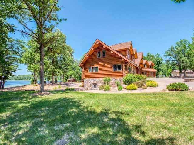 10719 Lumberjack Rd NW, Alaska Twp, MN 56667 - view of home's exterior featuring stone siding, log siding, a lawn, and a water view