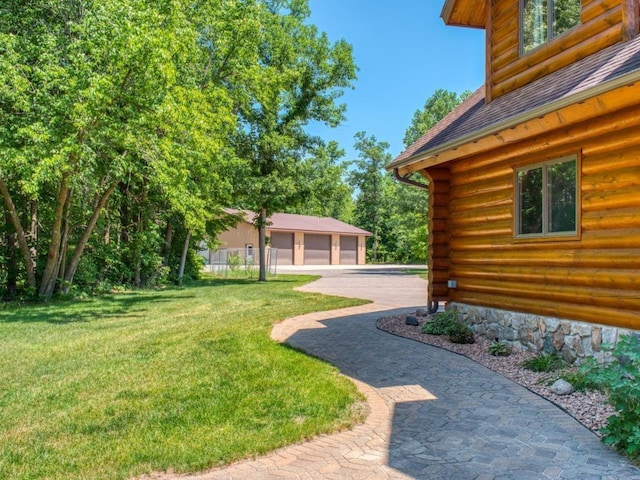 10719 Lumberjack Rd NW, Alaska Twp, MN 56667 - view of green lawn with a garage and an outbuilding