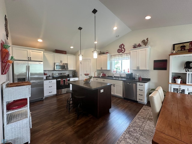 879 Longview Dr, Detroit Lakes, MN 56501 - kitchen with appliances with stainless steel finishes, dark countertops, a sink, dark wood-style floors, and lofted ceiling