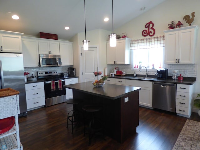 879 Longview Dr, Detroit Lakes, MN 56501 - kitchen with stainless steel appliances, a sink, dark countertops, tasteful backsplash, and vaulted ceiling