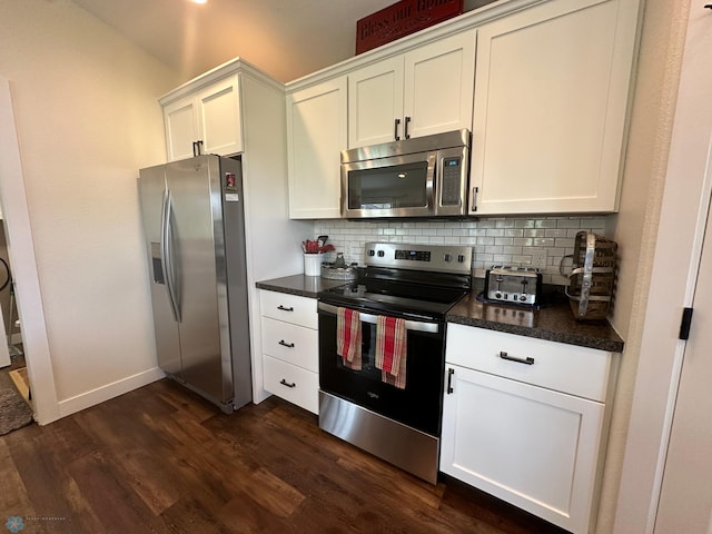 879 Longview Dr, Detroit Lakes, MN 56501 - kitchen featuring appliances with stainless steel finishes, dark countertops, dark wood-style floors, decorative backsplash, and white cabinets