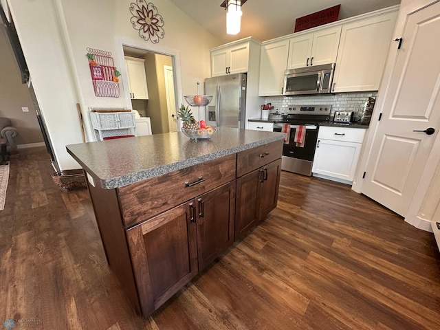 879 Longview Dr, Detroit Lakes, MN 56501 - kitchen featuring stainless steel appliances, dark countertops, dark wood-style flooring, tasteful backsplash, and white cabinetry