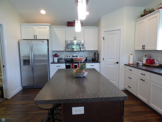 879 Longview Dr, Detroit Lakes, MN 56501 - kitchen with appliances with stainless steel finishes, dark countertops, decorative backsplash, white cabinets, and recessed lighting