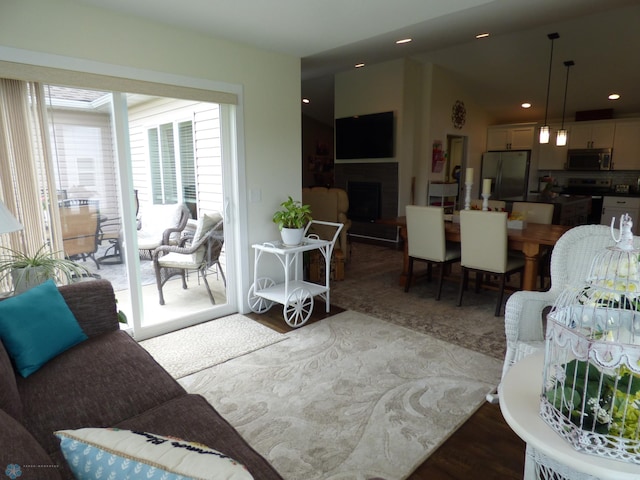 879 Longview Dr, Detroit Lakes, MN 56501 - living area featuring wood finished floors, a fireplace with raised hearth, and recessed lighting