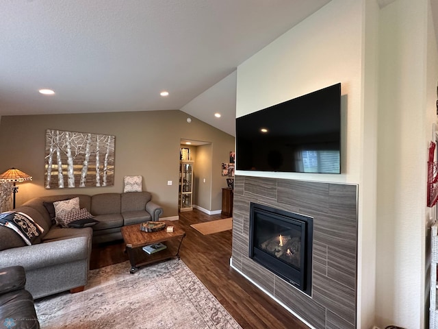 879 Longview Dr, Detroit Lakes, MN 56501 - living area with wood finished floors, lofted ceiling, a tiled fireplace, baseboards, and recessed lighting