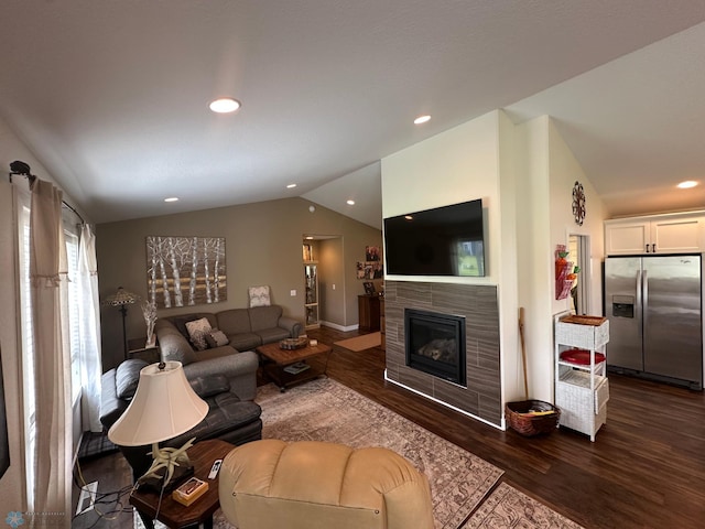 879 Longview Dr, Detroit Lakes, MN 56501 - living room featuring vaulted ceiling, dark wood finished floors, a tiled fireplace, and recessed lighting