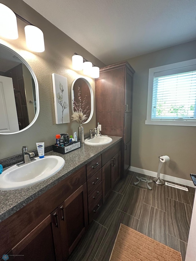 879 Longview Dr, Detroit Lakes, MN 56501 - full bathroom with double vanity and baseboards