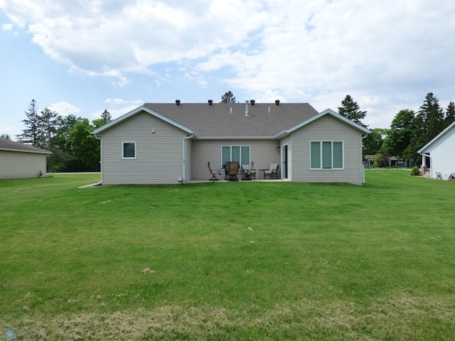 879 Longview Dr, Detroit Lakes, MN 56501 - back of property with a lawn, a patio, and a shingled roof