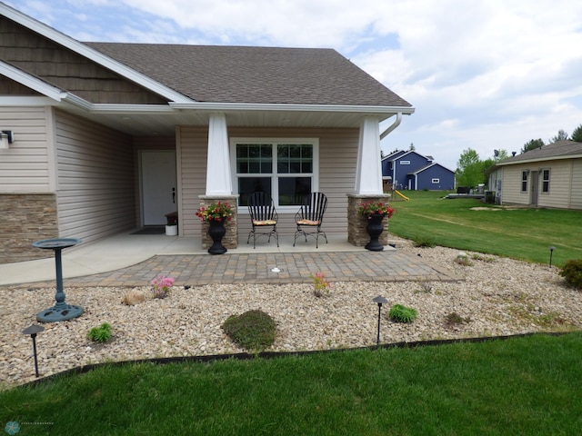 879 Longview Dr, Detroit Lakes, MN 56501 - entrance to property featuring a porch, a yard, and a shingled roof