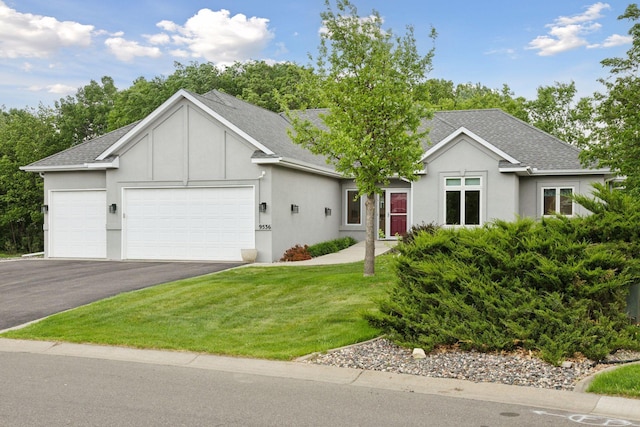 9536 Windflower Pl, Champlin, MN 55316 - ranch-style house featuring an attached garage, driveway, stucco siding, and a front lawn
