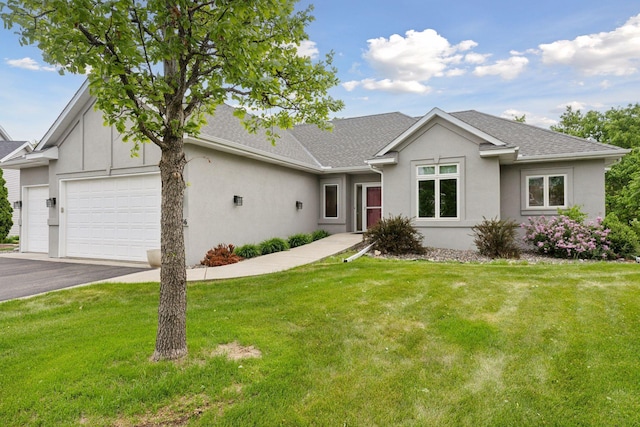 9536 Windflower Pl, Champlin, MN 55316 - view of front facade with stucco siding, a garage, a front lawn, and a shingled roof
