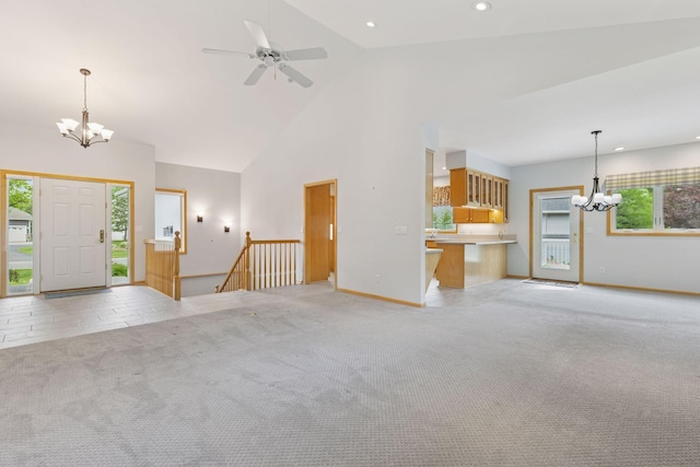 9536 Windflower Pl, Champlin, MN 55316 - unfurnished living room with a chandelier, recessed lighting, light colored carpet, high vaulted ceiling, and baseboards