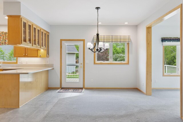 9536 Windflower Pl, Champlin, MN 55316 - kitchen with plenty of natural light, a chandelier, glass insert cabinets, light countertops, and recessed lighting