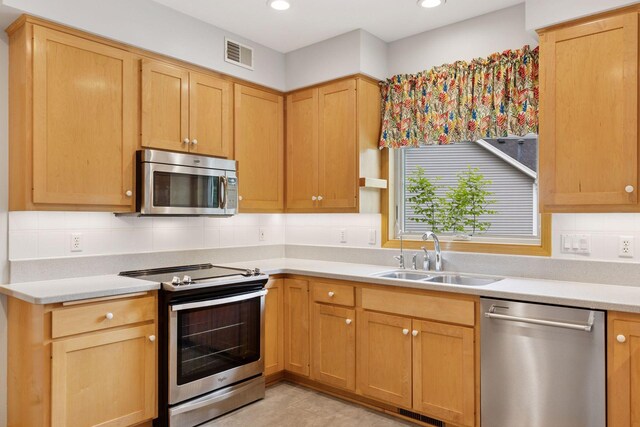 9536 Windflower Pl, Champlin, MN 55316 - kitchen with stainless steel appliances, a sink, light countertops, tasteful backsplash, and recessed lighting