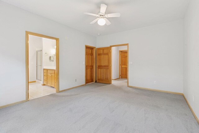9536 Windflower Pl, Champlin, MN 55316 - unfurnished bedroom featuring light colored carpet, baseboards, connected bathroom, and a ceiling fan