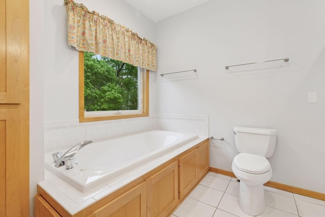9536 Windflower Pl, Champlin, MN 55316 - bathroom featuring toilet, a bath, tile patterned flooring, and baseboards