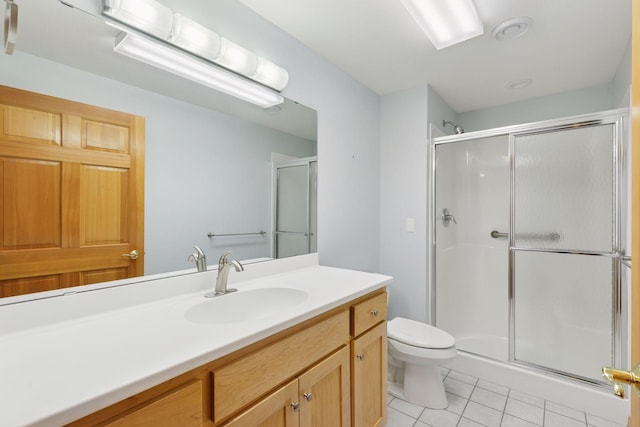 9536 Windflower Pl, Champlin, MN 55316 - bathroom featuring tile patterned floors, a shower stall, toilet, and vanity