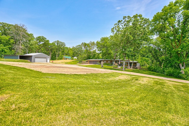 1970 Saint Croix Trl N, West Lakeland Twp, MN 55082 - view of green lawn featuring an outdoor structure, view of scattered trees, and a detached garage