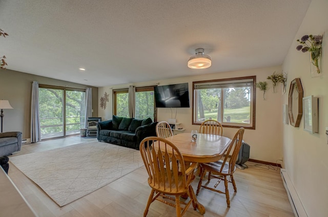 1970 Saint Croix Trl N, West Lakeland Twp, MN 55082 - dining room with a baseboard radiator, plenty of natural light, a textured ceiling, baseboards, and recessed lighting