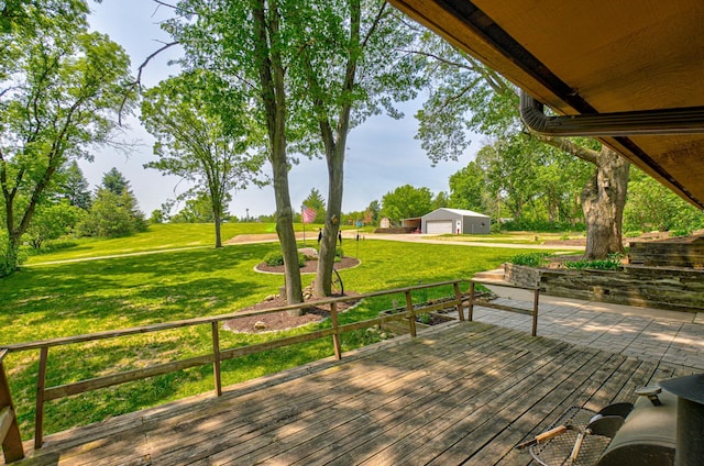 1970 Saint Croix Trl N, West Lakeland Twp, MN 55082 - deck featuring a detached garage, a lawn, and an outbuilding