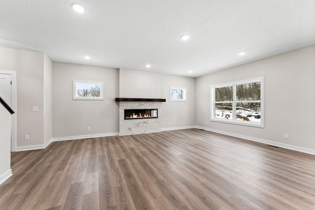 1700 Misty Cir, Buffalo, MN 55313 - unfurnished living room featuring wood finished floors, a fireplace, baseboards, and recessed lighting