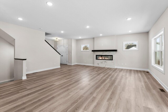 1700 Misty Cir, Buffalo, MN 55313 - unfurnished living room with light wood finished floors, healthy amount of natural light, baseboards, and recessed lighting
