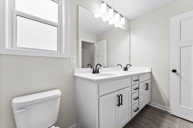 1700 Misty Cir, Buffalo, MN 55313 - bathroom with toilet, double vanity, baseboards, and wood finished floors