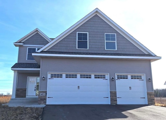 1700 Misty Cir, Buffalo, MN 55313 - view of front of property featuring stone siding, asphalt driveway, and an attached garage