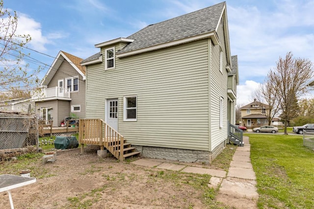 319 60th Ave W, Duluth, MN 55807 - back of property featuring a shingled roof, a wooden deck, and a lawn