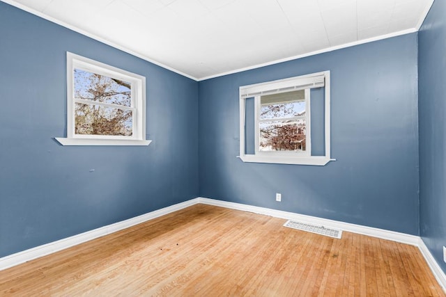 319 60th Ave W, Duluth, MN 55807 - spare room featuring wood finished floors, ornamental molding, and baseboards