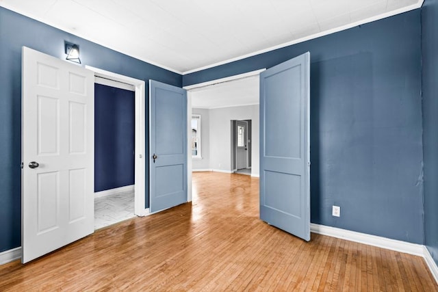 319 60th Ave W, Duluth, MN 55807 - spare room featuring baseboards, light wood-type flooring, and ornamental molding